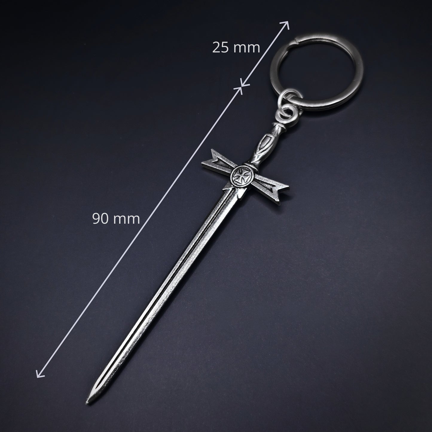 Silver sword-shaped keychain with measurements on a dark background