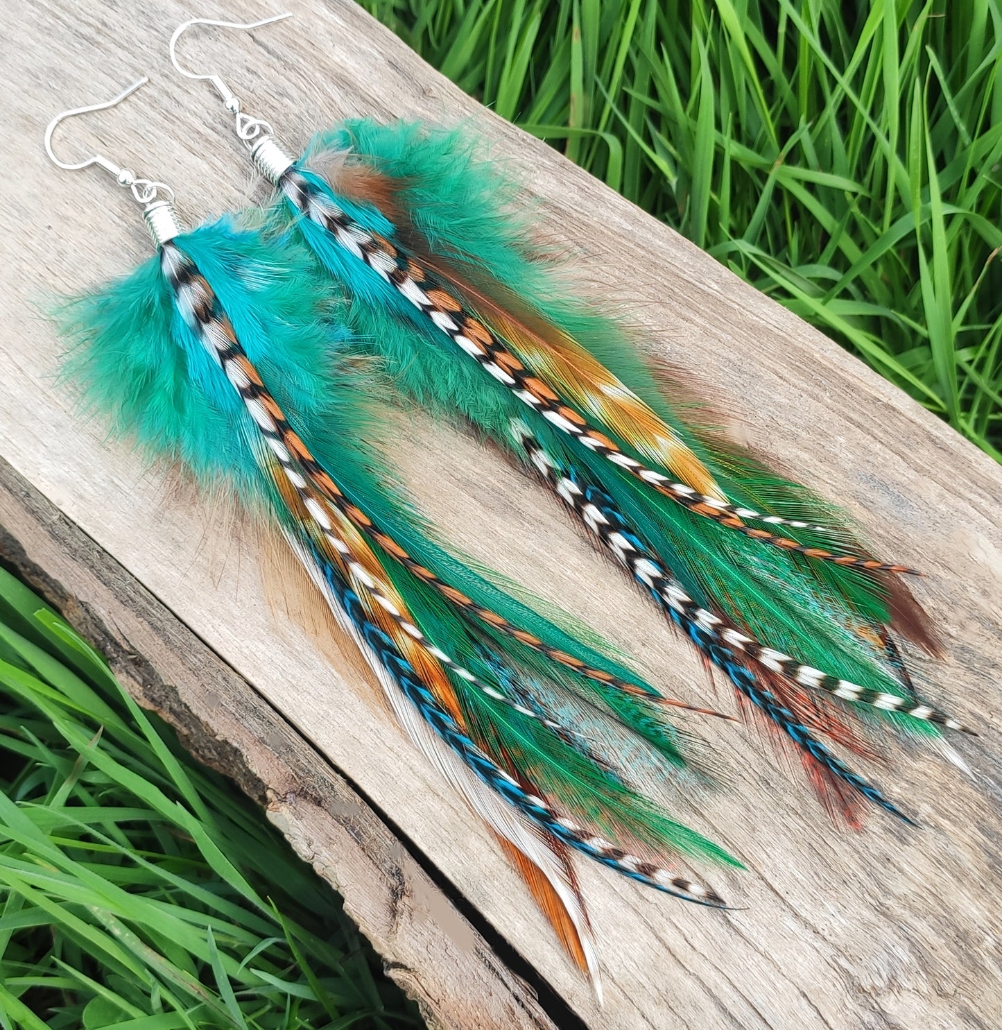 Rustic green and brown feather earrings. The feathers have intricate and delicate markings and show off the beauty of nature.