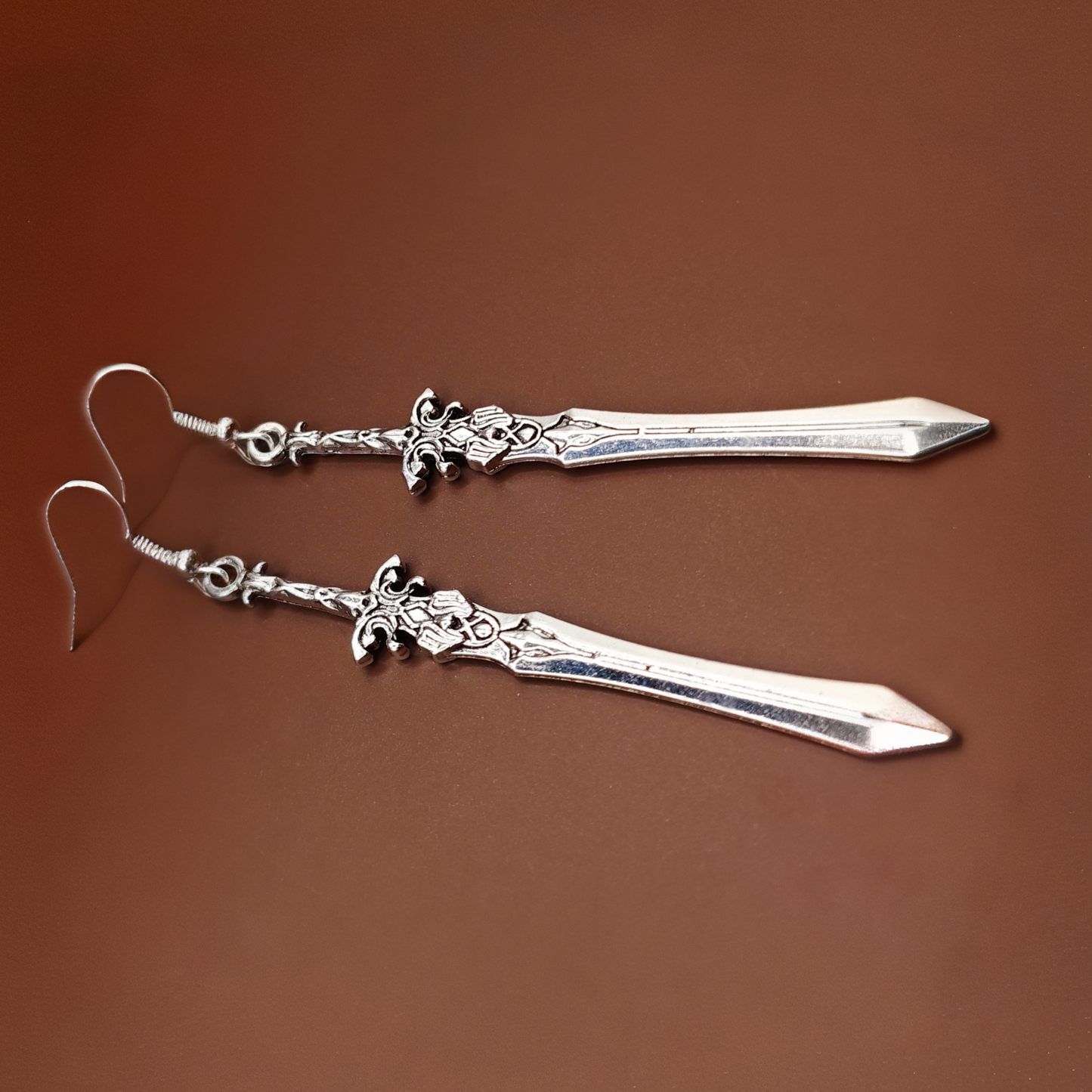 Lightweight long sword earrings made of alloy and stainless steel, ideal for medieval costumes.
