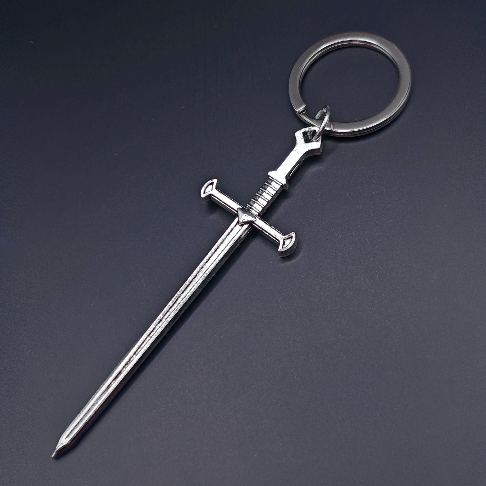 Sword keychain on a dark background