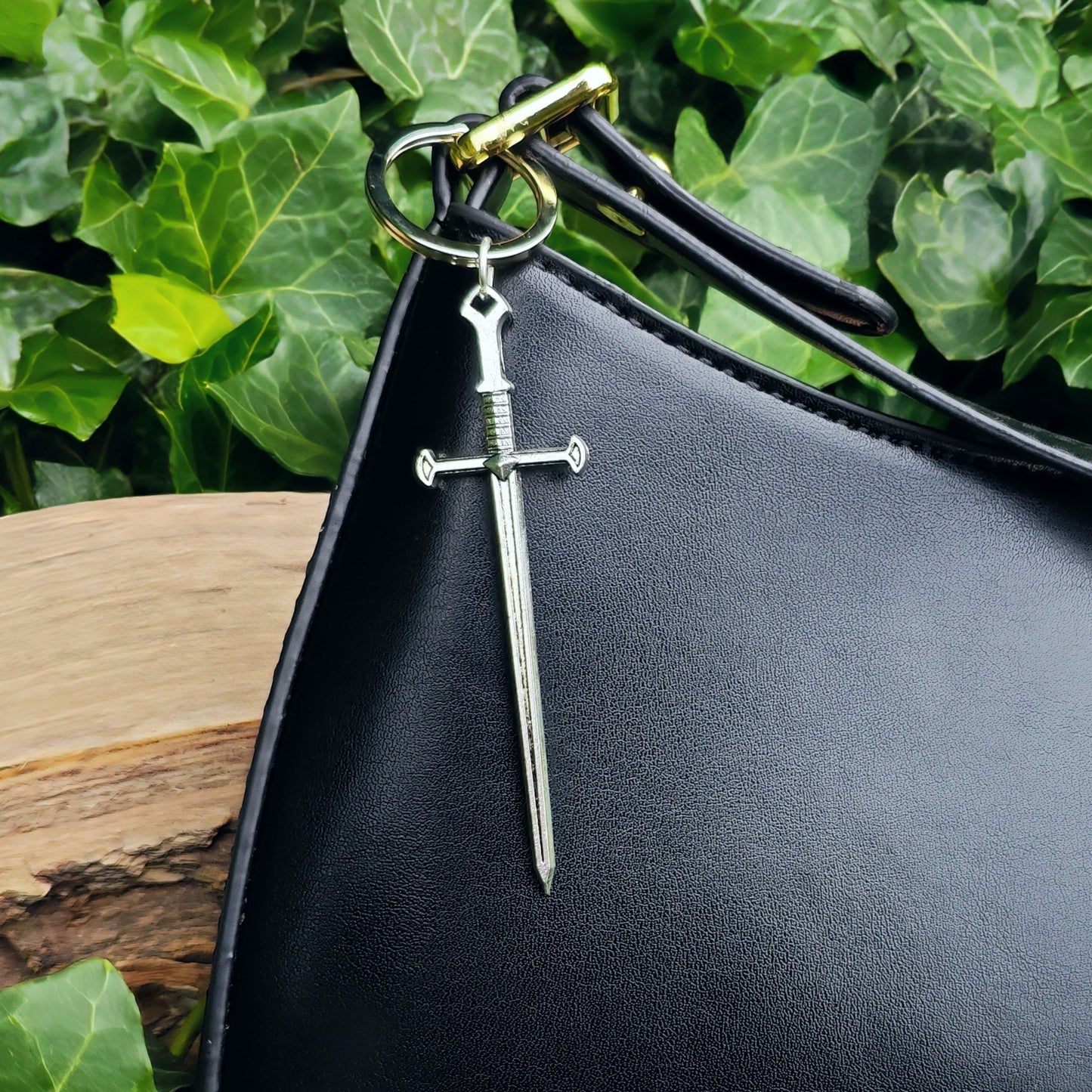 Sword keyring shown on a black handbag as a charm or bag accessory