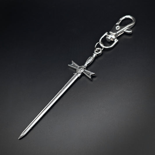 Silver sword keyring with a cross design on a black background