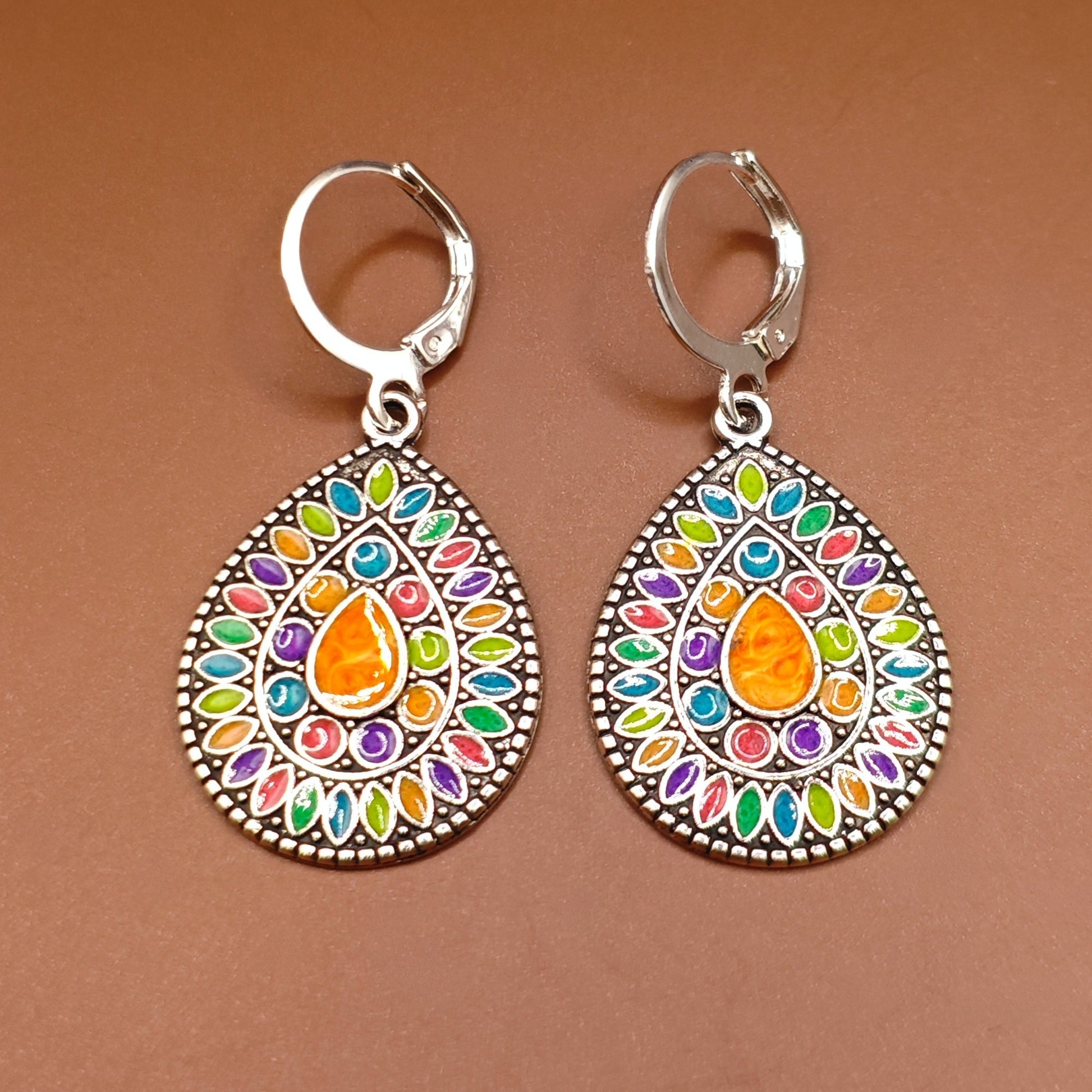 Colourful boho hippie style ethnic earrings with teardrop design, on a brown background