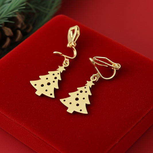 Festive Christmas tree earrings with clip-ons made from gold stainless steel on red velvet.