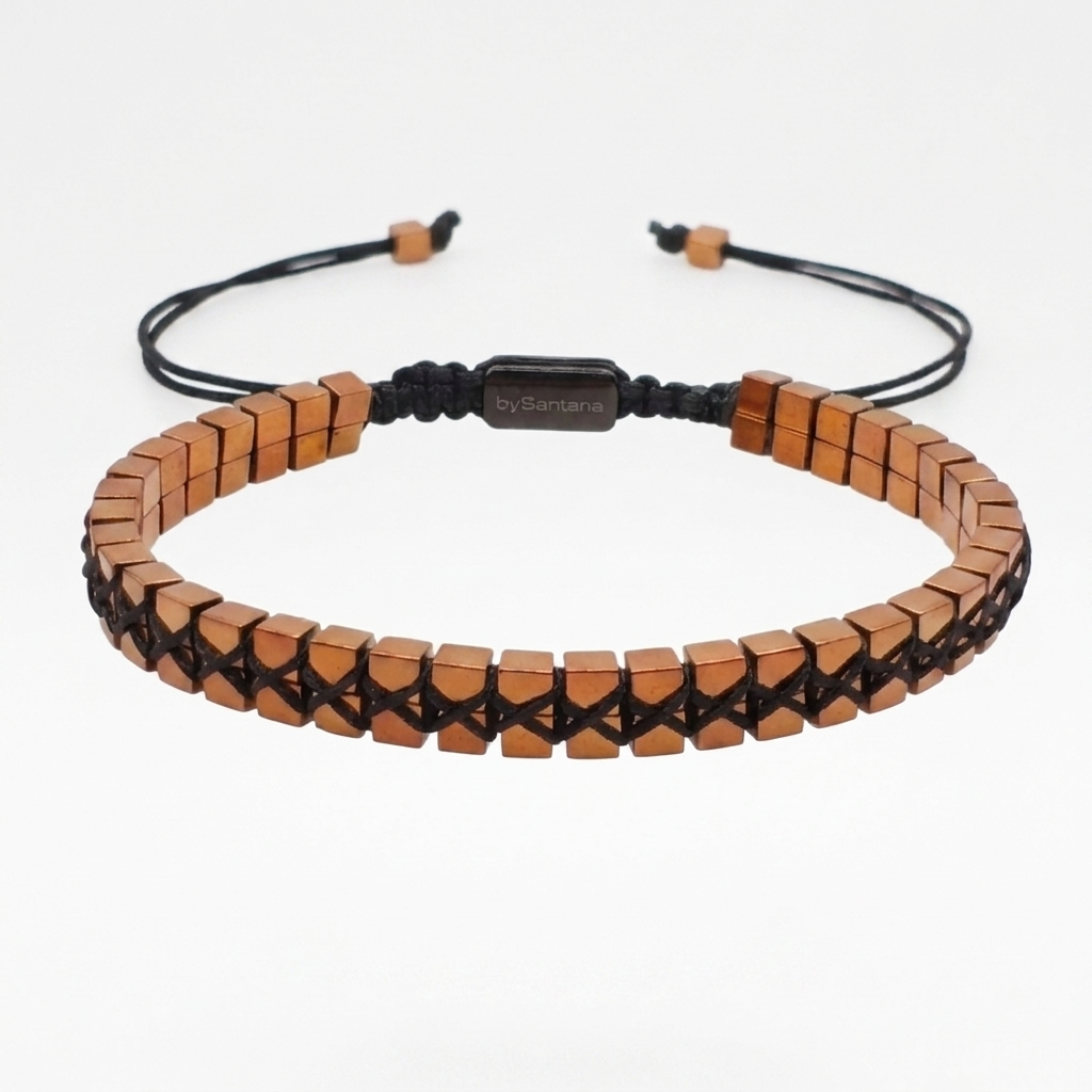 A copper hematite bracelet with cube beads woven together on a white background