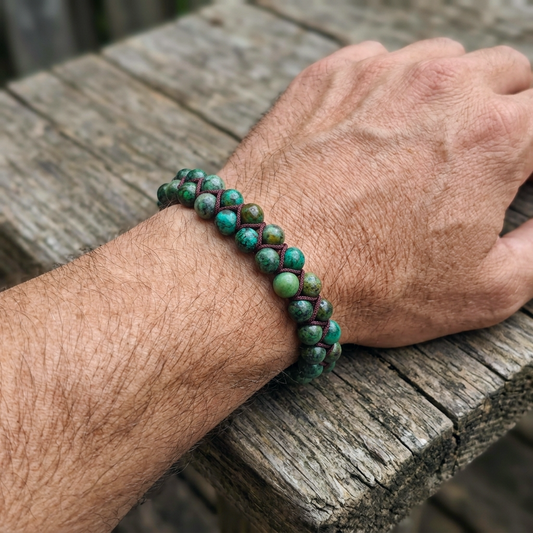 African Turquoise beaded bracelet featuring a double row of beads on a man's wrist with a wooden background