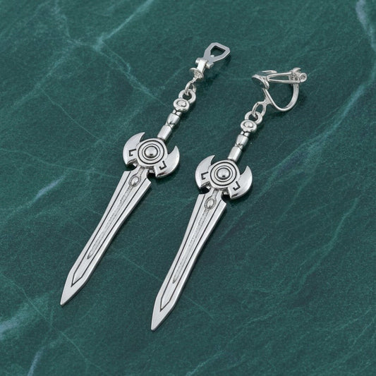 Silver sword earrings with clip ons on a green marble surface