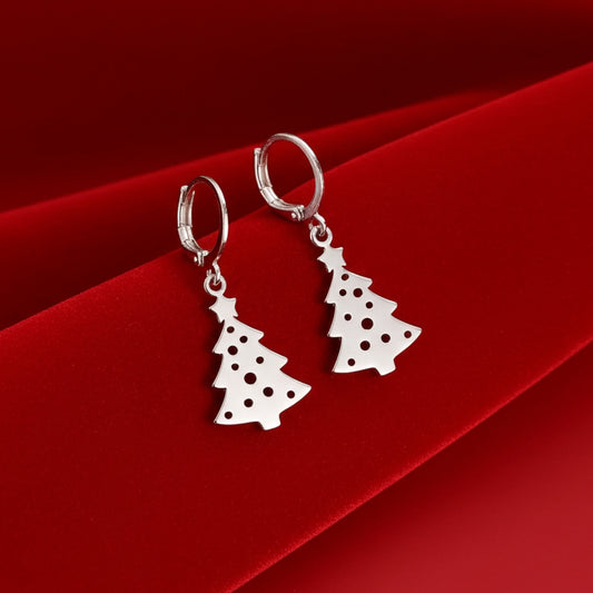 Silver Christmas tree earrings with hoops on a red velvet background