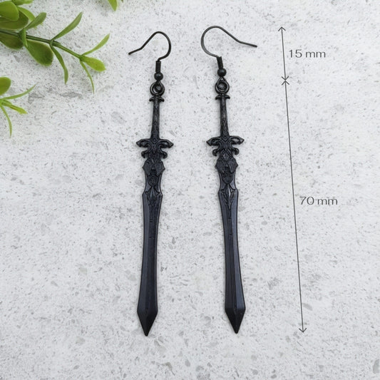 long black sword earrings on a light stone background with measurements