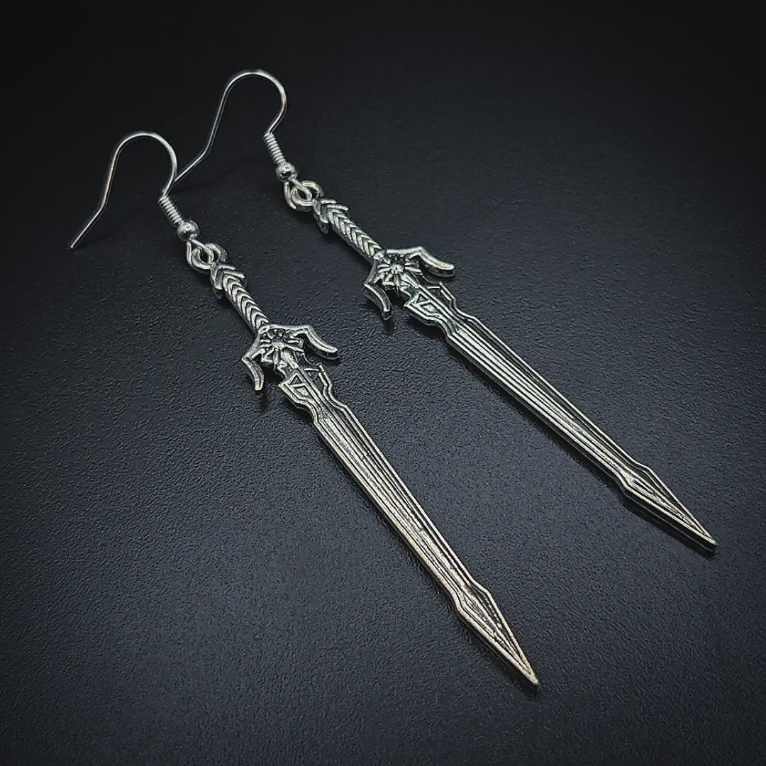 Video of long silver sword earrings with a medieval fantasy style