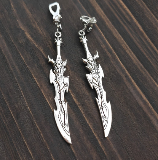 Clip on sword earrings with a silver curved fantasy blade design. A unique gift for RPG players, LARP fans, or gamers.