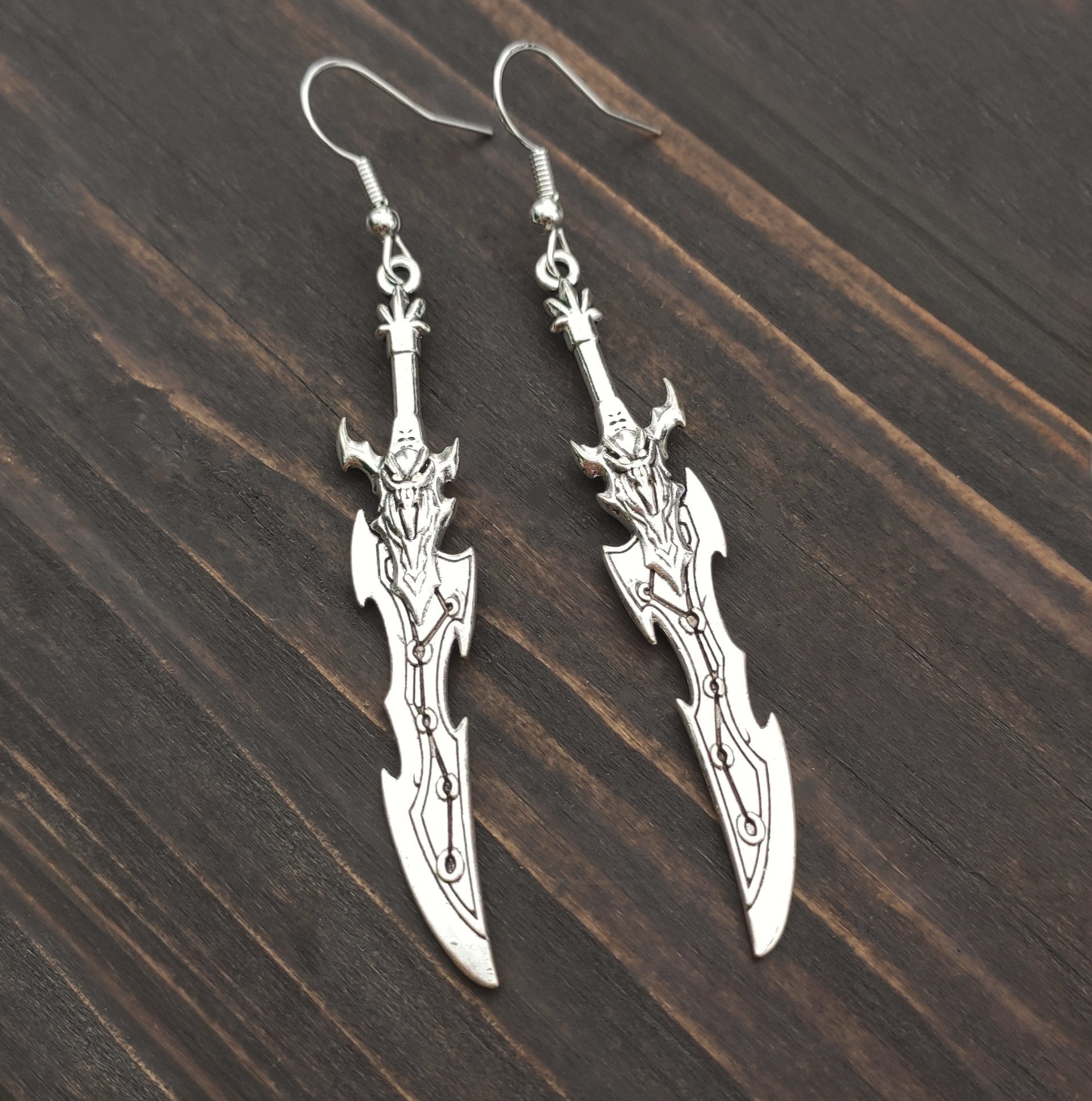 Silver sword earrings with a curved fantasy blade design. A unique gift for RPG players, LARP fans, or gamers.