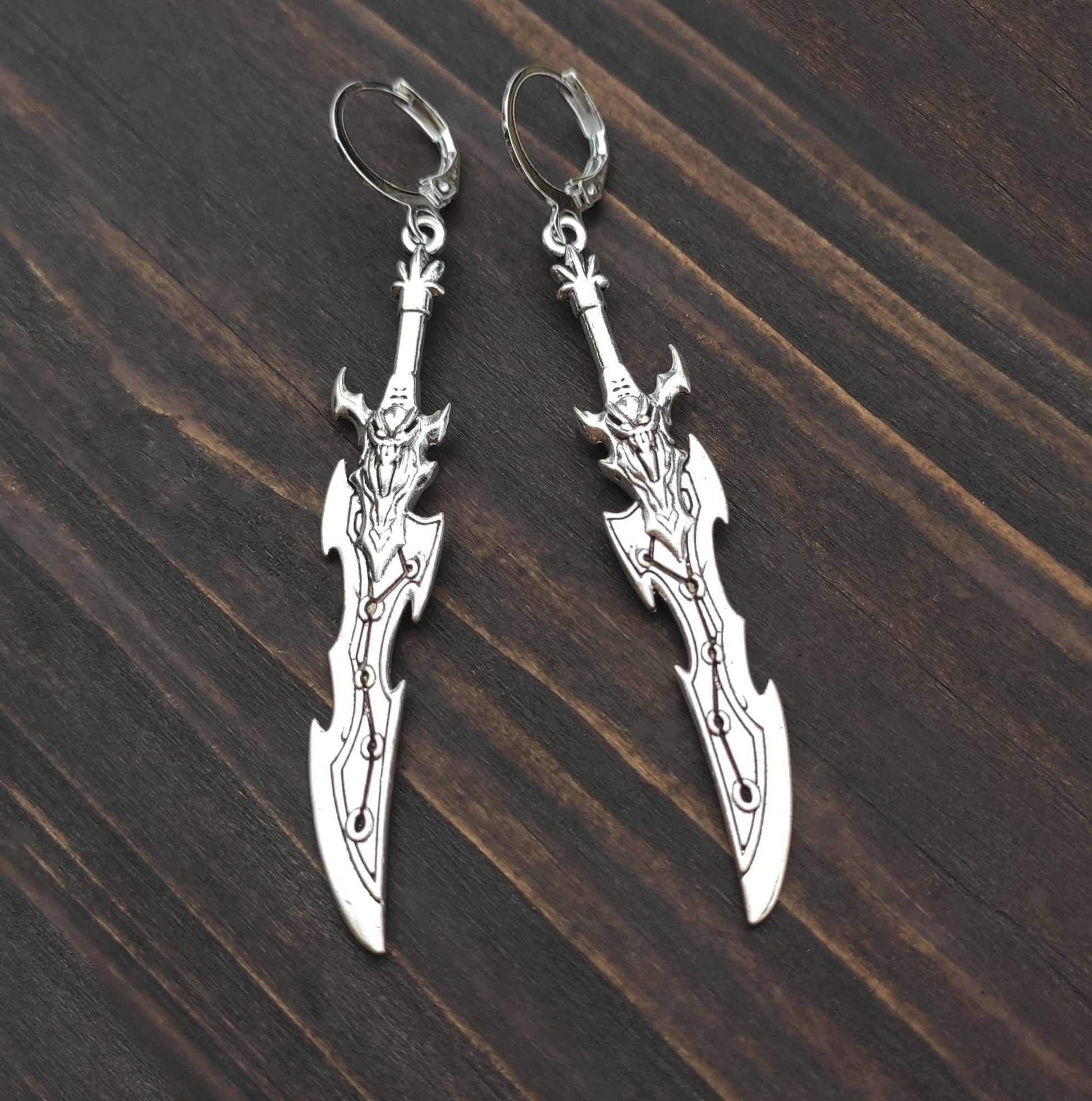Silver sword earrings with a curved fantasy blade design. A unique gift for RPG players, LARP fans, or gamers.