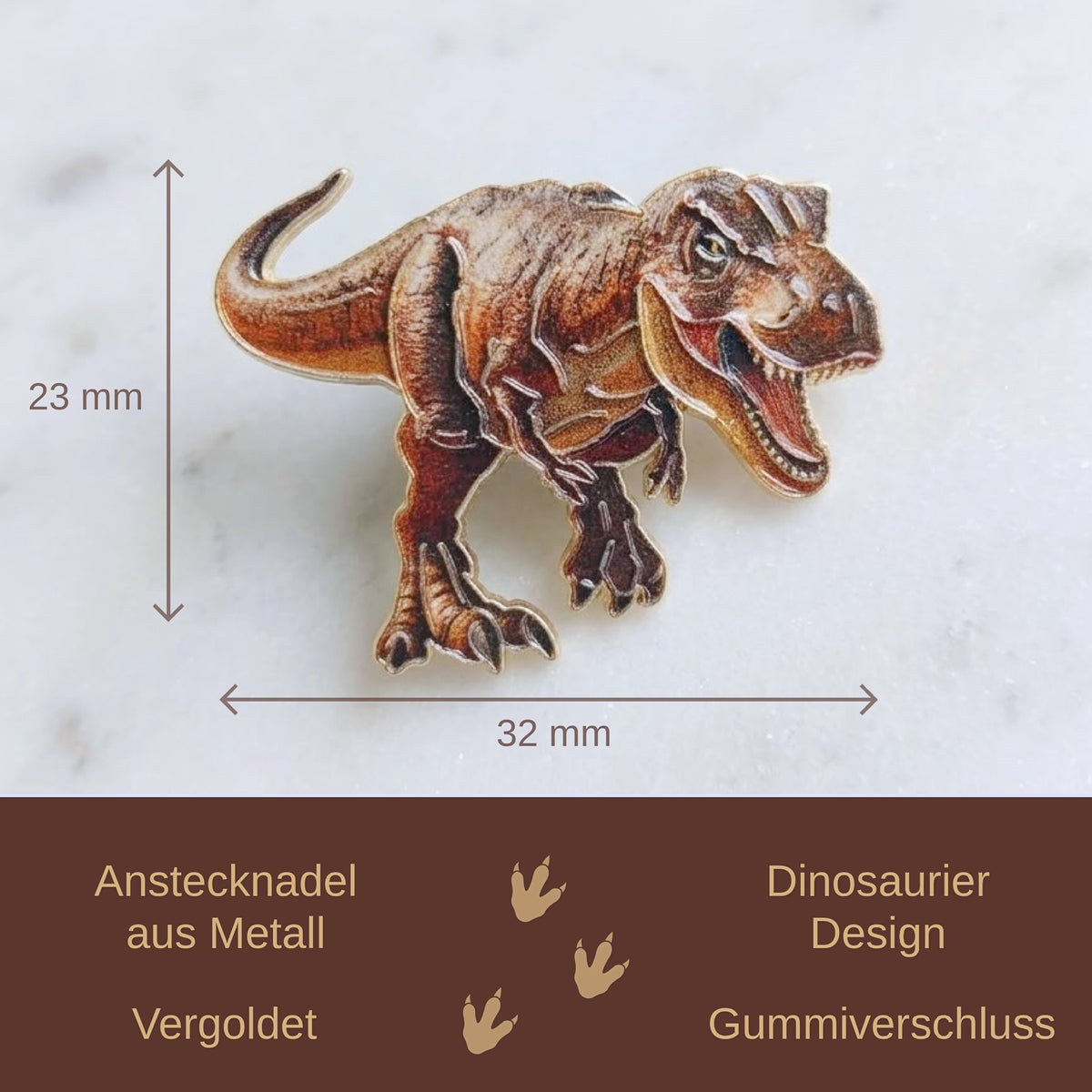 A dinosaur-shaped metal pin shown on a light marble-like background with measurement arrows indicating 23 mm height and 32 mm width. A dark brown banner at the bottom contains German text describing the product features.