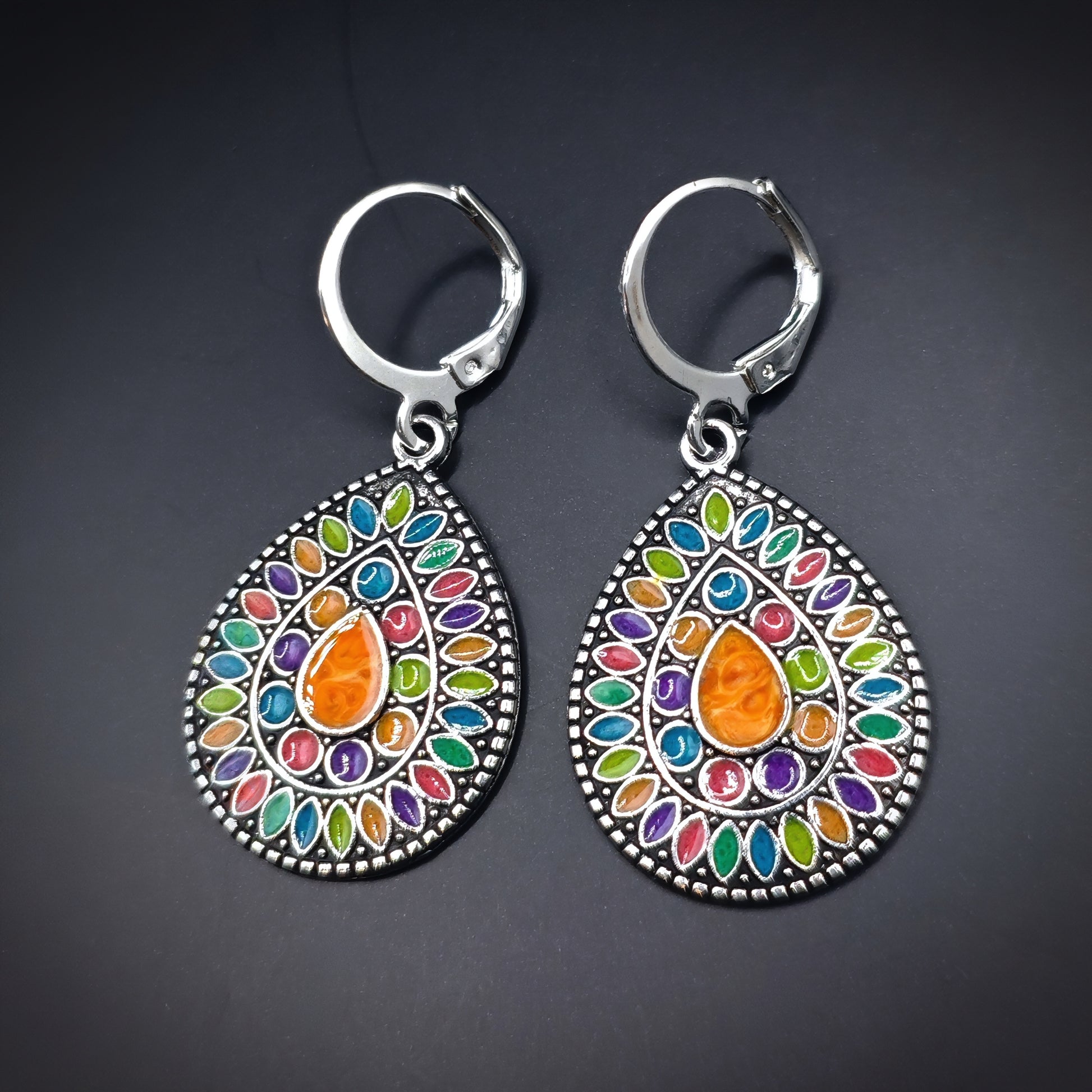 Colorful drop earrings with teardrop-shaped multicolored enamel designs. Ethnic boho hippie style 