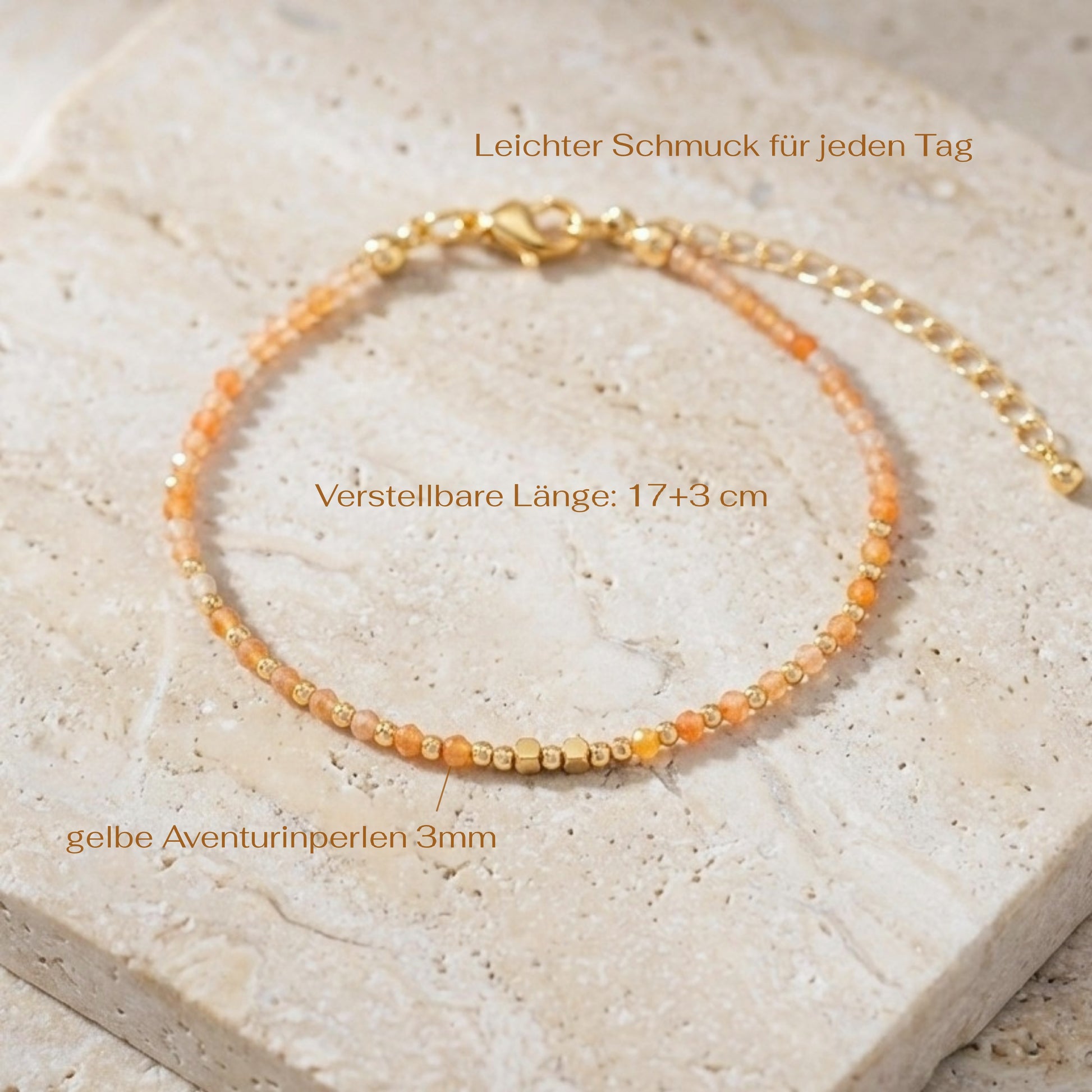 Yellow aventurine beaded boho bracelet with gold spacer beads and orange gemstone beads, on a light stone background with measurements