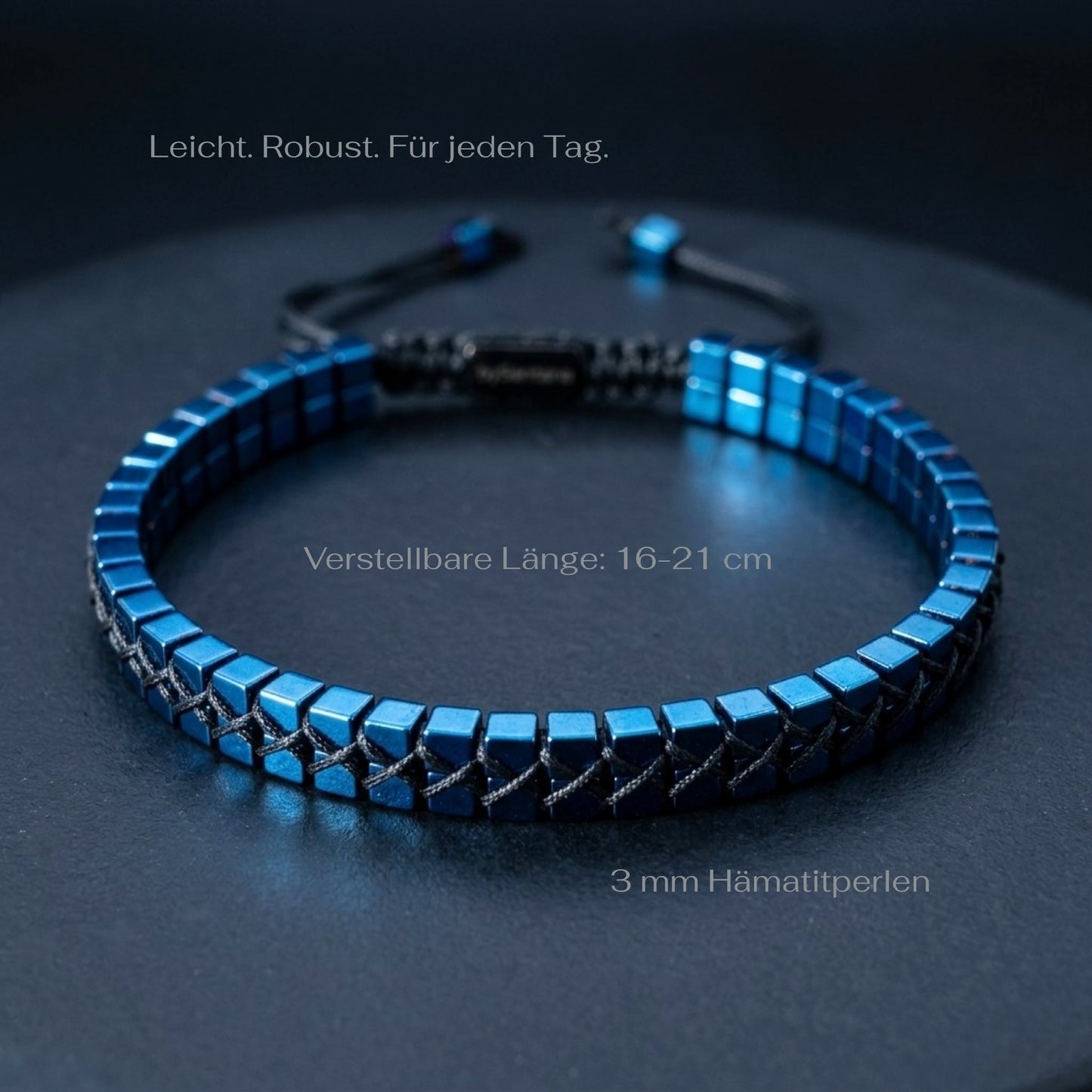 Blue beaded bracelet on a dark surface with measurements