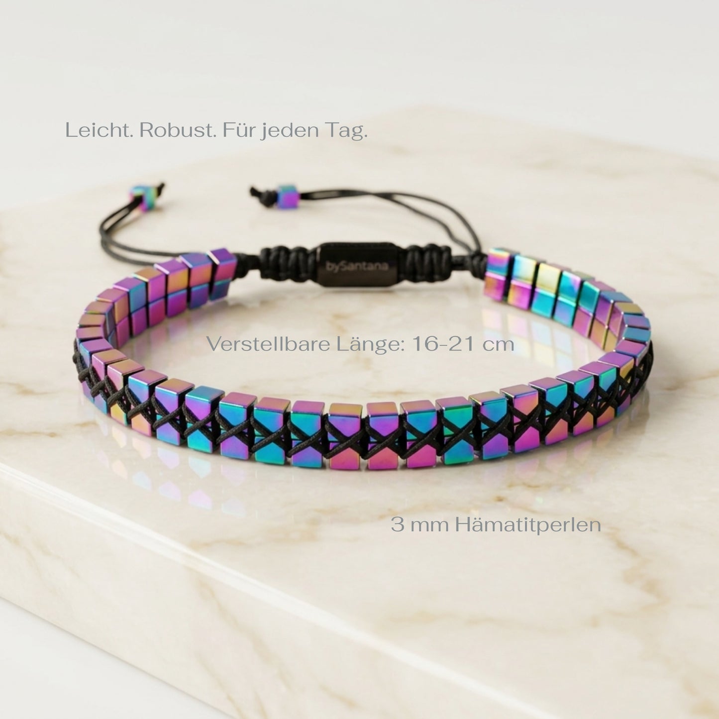 A men's metallic multicolour rainbow Hematite beaded bracelet with cube beads and adjustable cord on a marble surface with measurements