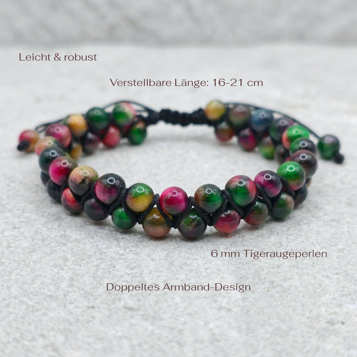 Colourful Tiger's Eye bracelet with a double row of pink, green and yellow gemstone beads, woven together with an adjustable drawstring. The bracelet sits on a light stone surface with measurements