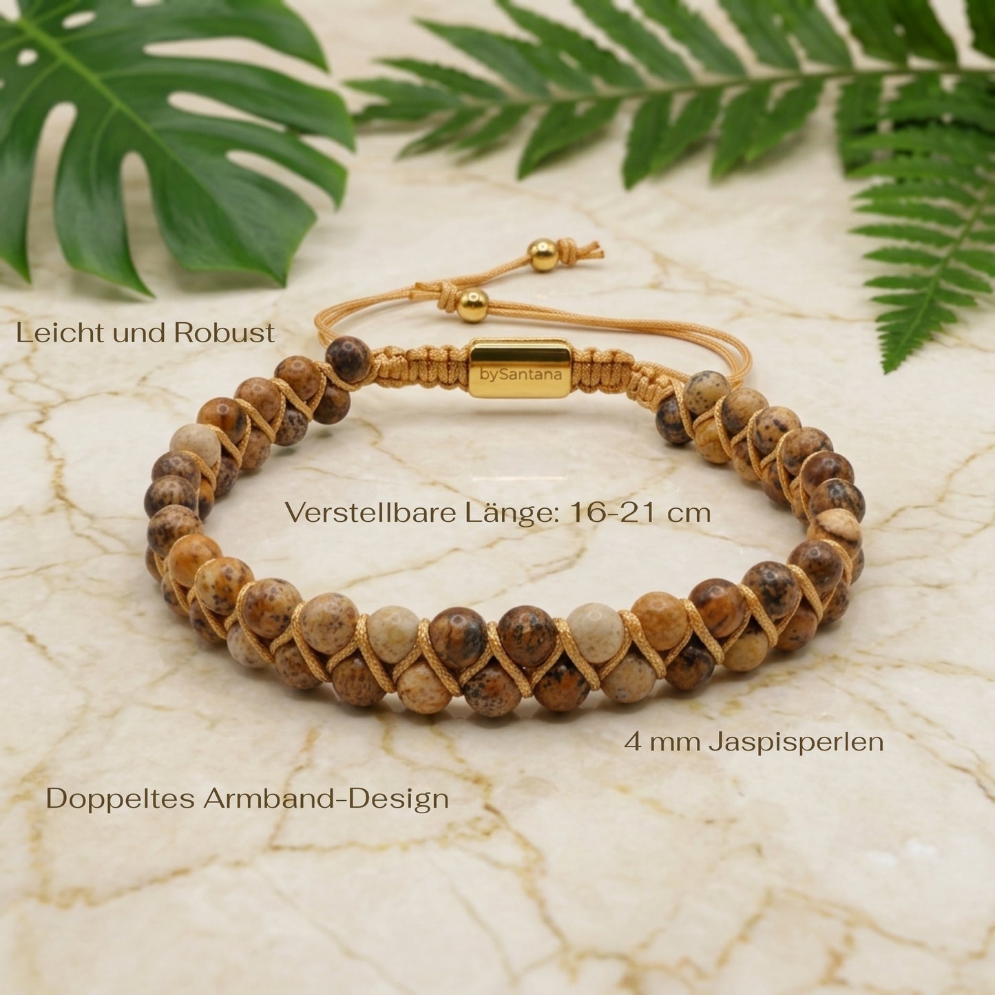 Beaded picture jasper gemstone bracelet with braided design on a marble surface with green leaves and measurements shown