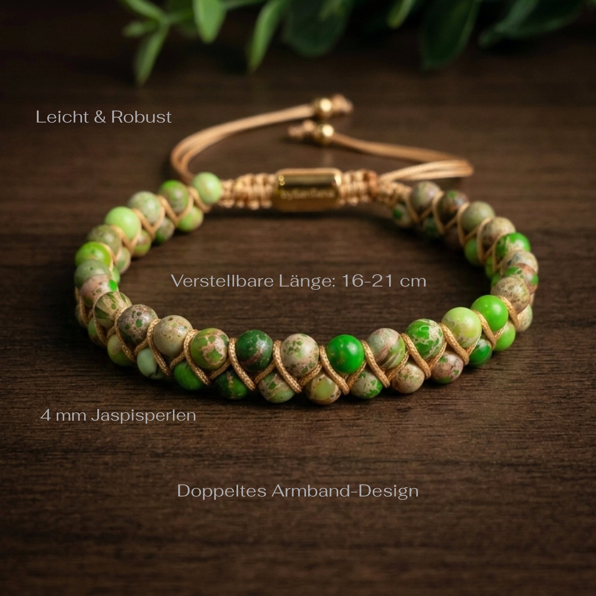Green sea sediment jasper beaded bracelet with gold clasp on a wood surface with green leaves in the background and measurements shown