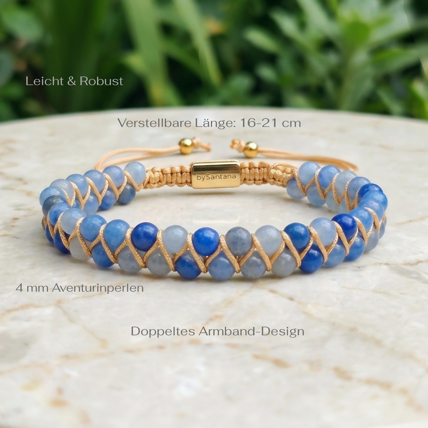 Blue aventurine beaded gemstone  bracelet with gold accents on a marble surface with greenery in the background and measurements shown