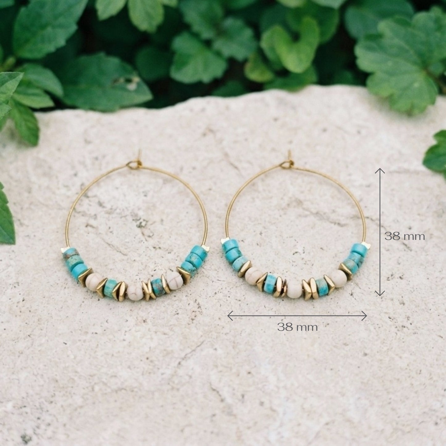 Boho style gold copper wire hoop earrings with light blue sea sediment jasper and stainless steel beads, on a marble surface