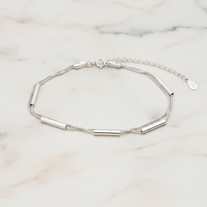 925 Silver Bracelet featuring two Venetian box chains and long silver beads on a light marble background