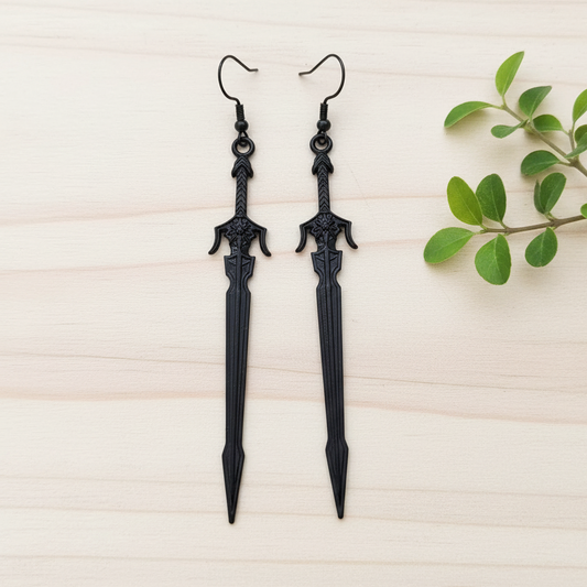 long black medieval sword earrings on a wooden background