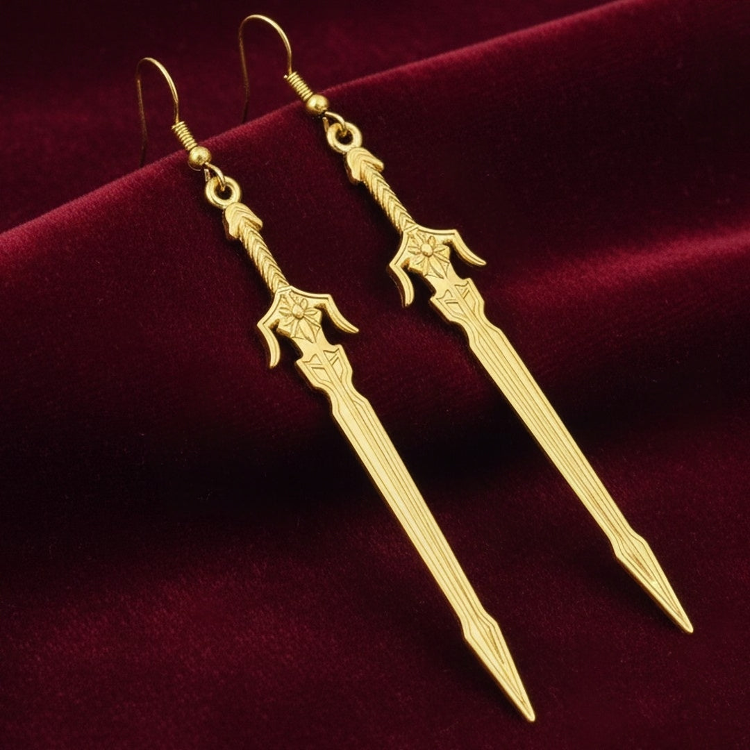 Medieval style fantasy long gold sword earrings with hooks on a red background