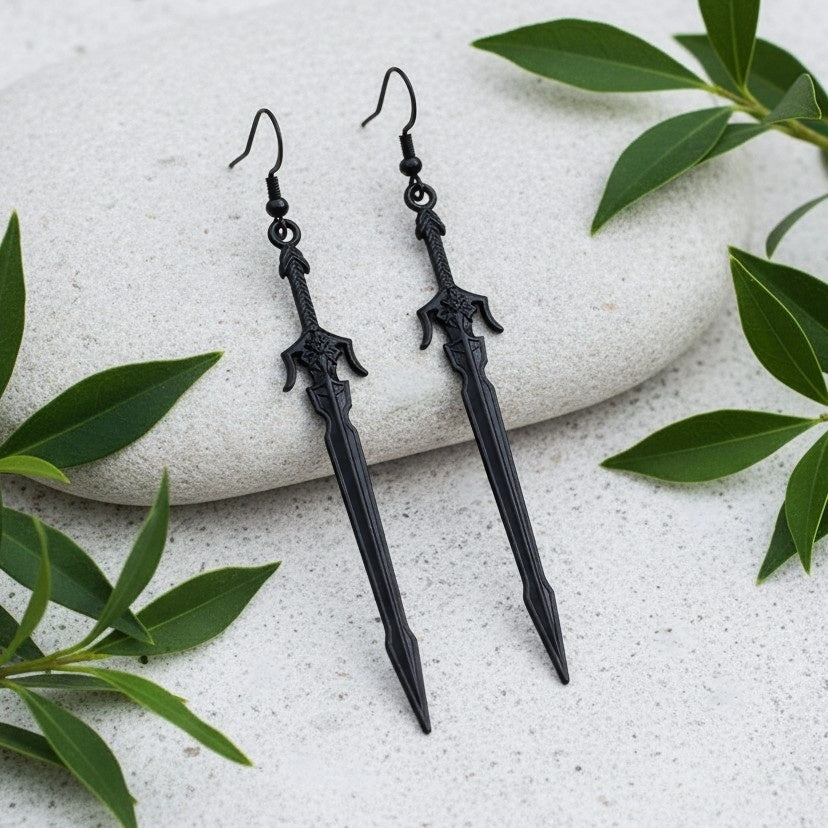 long black medieval sword earrings on a stone background