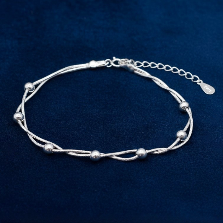 925 Silver Bracelet with two intertwined snake chains and round beads, on a blue background.