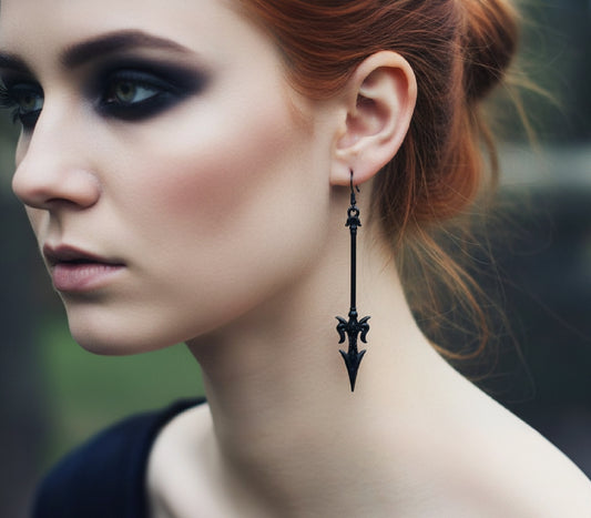 A gothic woman with red hair wearings long black mace or axe earrings