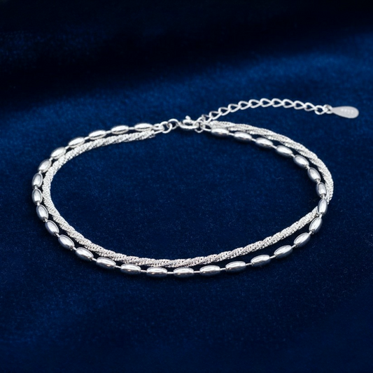 925 Silver Bracelet featuring a double chain, one twisted sparkle chain and one with oval beads, on a blue background