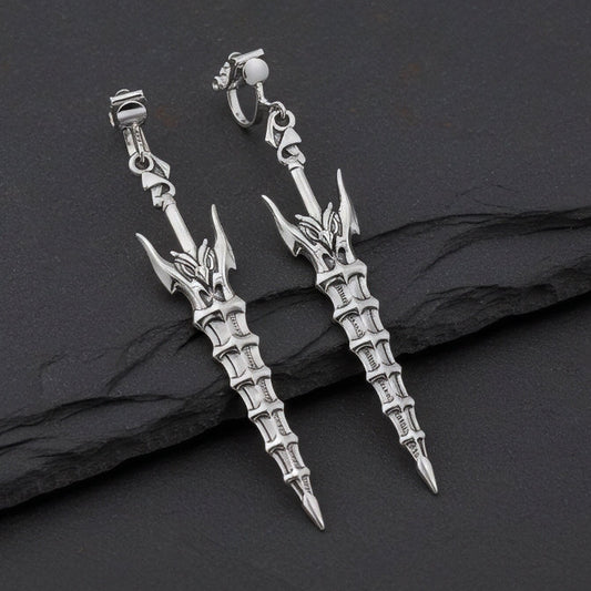 Fantasy silver sword earrings with clip-ons on a black stone background
