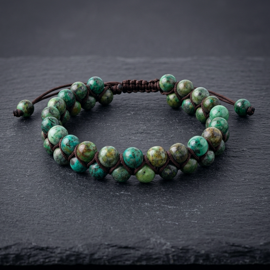 African Turquoise beaded bracelet featuring a double row of beads woven together with an adjustable cord, on a dark stone background