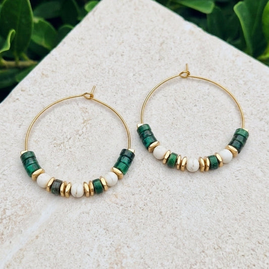 Boho style gold copper wire hoop earrings with green sea sediment jasper and stainless steel beads, on a marble surface
