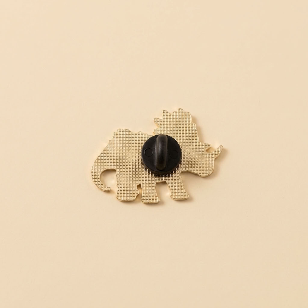 The back of the pin with a black rubber back, shown on a solid beige background.