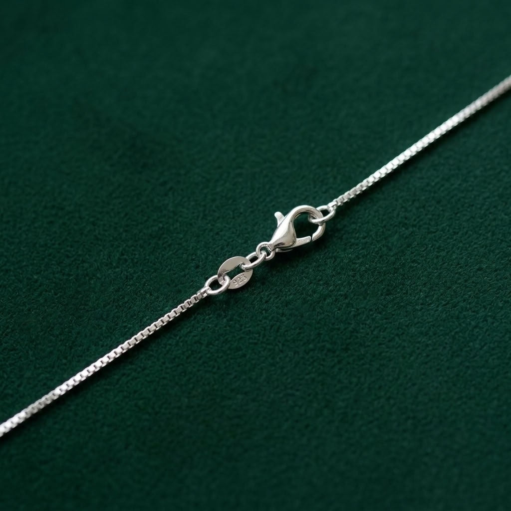 Close up of a 925 silver lobster clasp on a venetian box chain