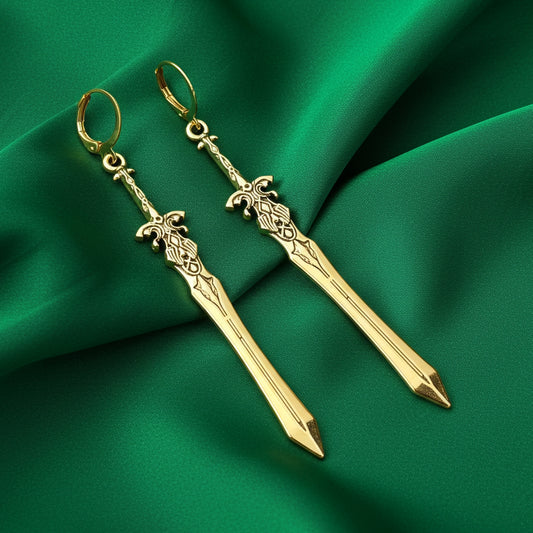 Fantasy gold sword earrings with hoops on a green background