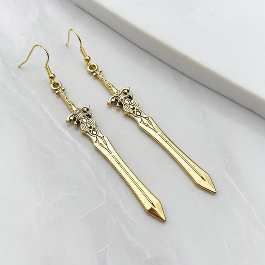 Fantasy gold sword earrings with hooks on a white background
