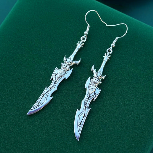 Fantasy silver sword earrings with hooks on a green background