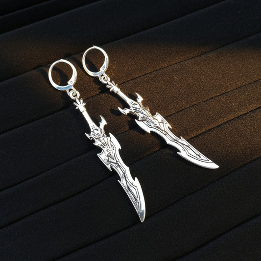 Fantasy silver sword earrings with hoops on a black background
