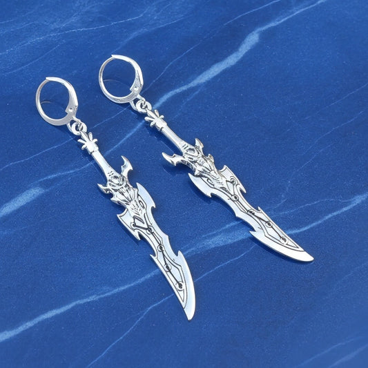 Silver sword earrings with hoops on a blue marble background