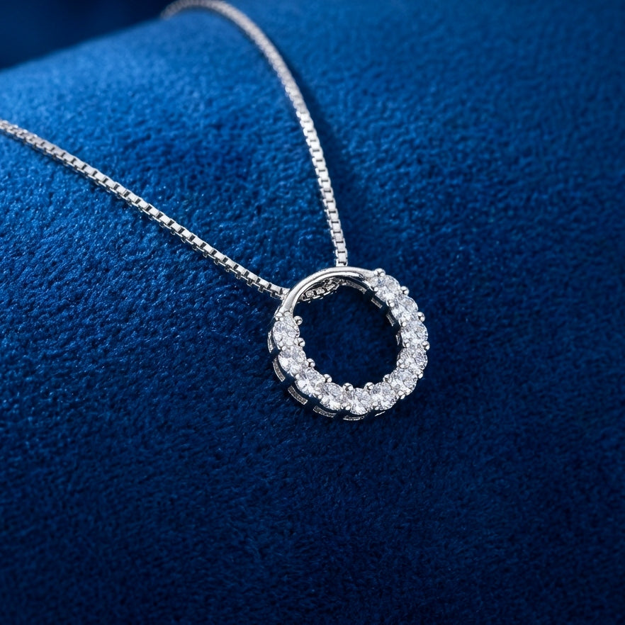 Sparkly round circle 925 silver pendant with crystals with a box chain necklace on a blue background