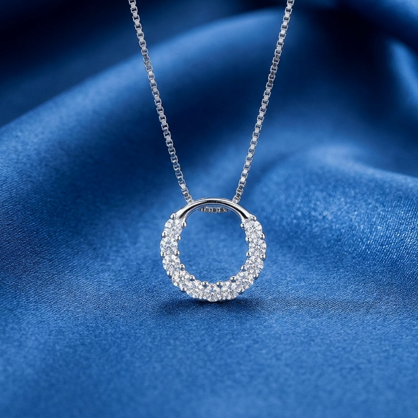 Sparkly round circle 925 silver pendant with crystals with a box chain necklace on a blue background