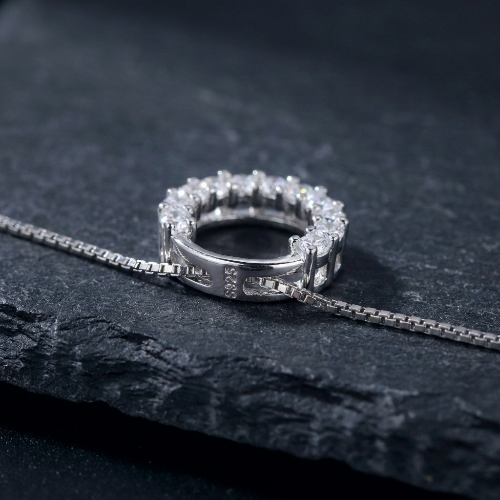 Sparkly round circle 925 silver pendant with crystals with a box chain necklace on a black background, showing the S925 stamp