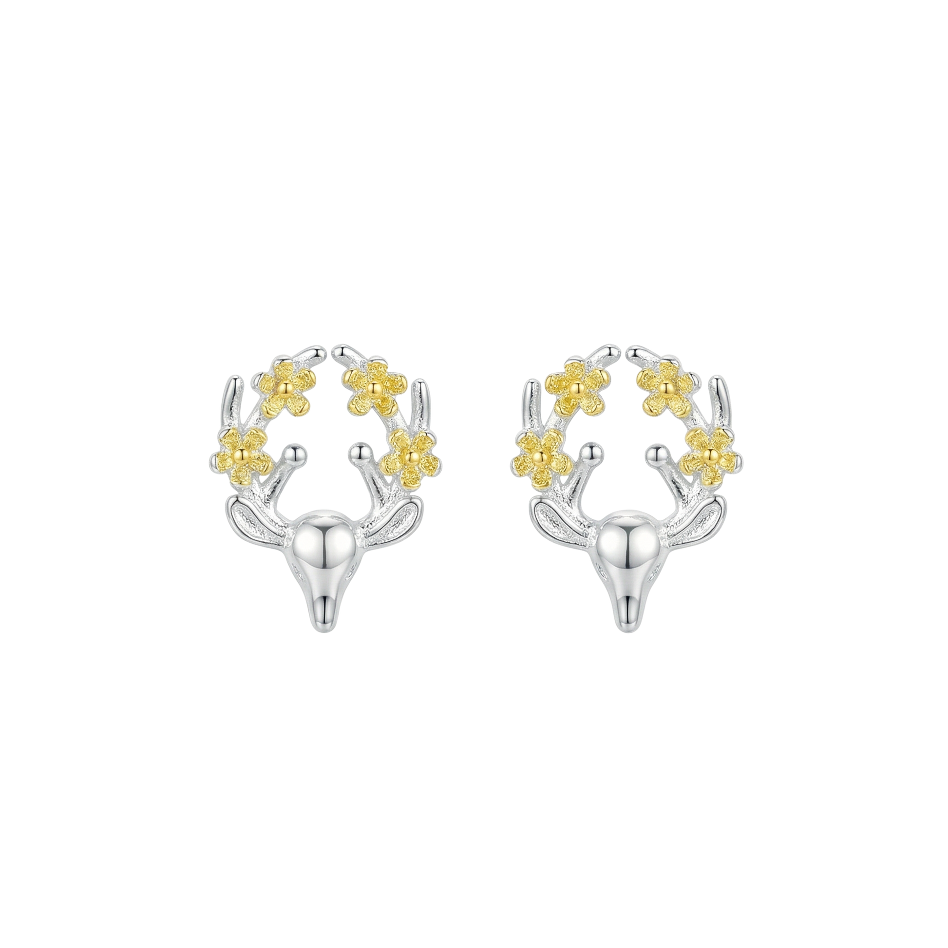 Silver and gold deer shaped earrings with floral details on the antlers on a white background