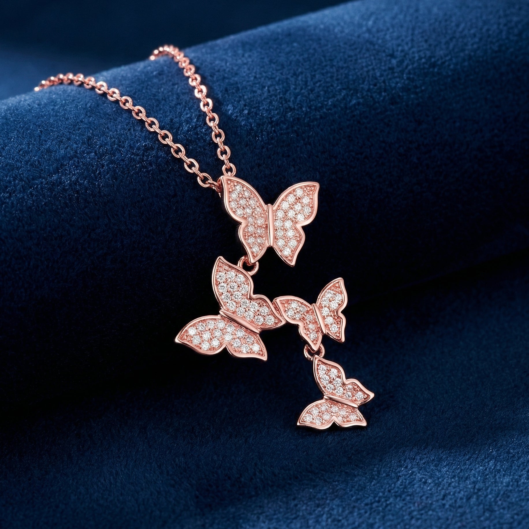 Rose gold butterfly necklace on a dark blue background