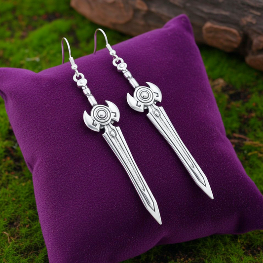 Fantasy silver sword earrings on a purple cushion with a natural background